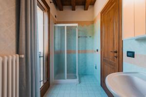 a bathroom with a shower and a tub and a sink at Agriturismo P rato Fiorito in Santi Angeli