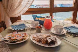 a table with plates of food on top of it at Agriturismo P rato Fiorito in Santi Angeli +45 photos
