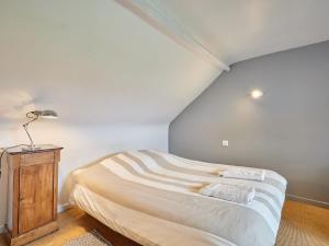 a bedroom with a bed and a lamp on a table at Holiday Home La Musardière by Interhome in Saint-Germain-des-Angles