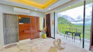 a hotel room with a view of a balcony at Cloudy Inn Resort in Bāndarban