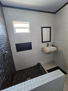 a bathroom with a sink and a mirror at Casa 264 in Capão da Canoa +16 photos