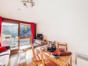 a living room with a table with a pot on it at Apartment Soyouz Vanguard-106 by Interhome in Le Corbier +28 photos