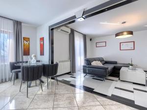 a living room with a couch and a table at Villa Elli by Interhome in Tinjan +36 photos