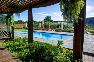 a backyard with a swimming pool and a patio at Regal Inn Ballito in Ballito