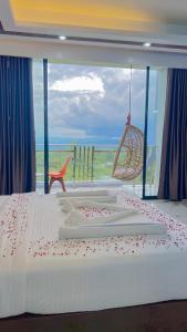 a bedroom with a bed with a view of the ocean at Cloudy Inn Resort in Bāndarban