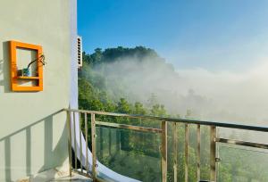 a balcony with a view of a mountain at Cloudy Inn Resort in Bāndarban