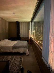 マイプにあるEl Atelierのベッドと大きな窓のある寝室