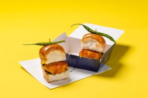 two sandwiches in a box on a yellow background at Round D Clock, IGI Airport in New Delhi