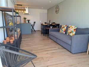 een woonkamer met een bank en een tafel bij Apartment Viva One by Interhome in Branqueira