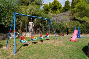 a playground with colorful swings in a park at Villa Nefeli Skiathos in Skiathos Town