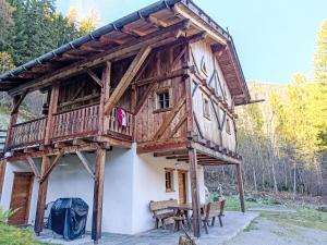 a log cabin with a balcony and a table at Chalet Maset Pozzati by Interhome in Bresimo +43 photos
