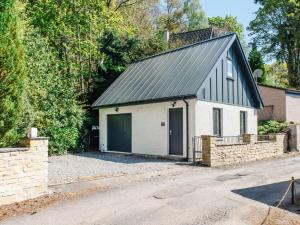 una casa con techo negro y garaje en Holiday Home Wayside Bothy by Interhome, en Drumnadrochit
