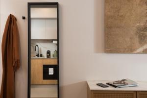 a kitchen with a mirror next to a table at master Wola in Warsaw +66 photos