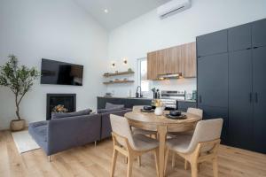 a living room with a table and a couch at Modern Comfort - Spa - Mountain - Chalet KNOX in Saint Come