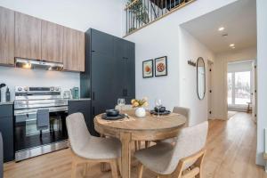 a kitchen with a wooden table and some chairs at Modern Comfort - Spa - Mountain - Chalet KNOX in Saint Come