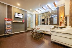 una sala de estar con un sofá y una mesa en Hotel Opera Delhi Airport, en Nueva Delhi
