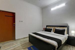 a bedroom with a large bed and a red door at AV Hotels in Lucknow