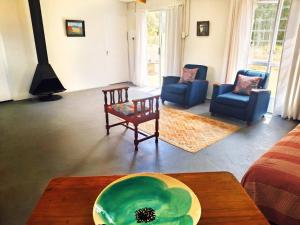 a living room with a couch and chairs and a table at Cornelia's Field in Joubertina