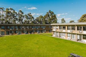 an exterior view of a building with a large lawn at The Reserve Hotel in Sale