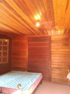 a bedroom with a bed in a wooden room at Relax with the whole family in this accommodation in Belas