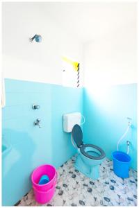 a bathroom with a toilet and two buckets at Hotel JK Seaside Inn Near Jagannath Temple - Fully Air Conditioning Deluxe Room - Free Wifie and Parking - Rooftop Sea View Hotel In Puri in Puri