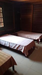 two beds in a room with white sheets at Relax with the whole family in this accommodation in Belas