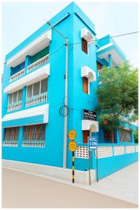 a blue building with a sign in front of it at Hotel JK Seaside Inn Near Jagannath Temple - Fully Air Conditioning Deluxe Room - Free Wifie and Parking - Rooftop Sea View Hotel In Puri in Puri