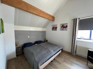 Giường trong phòng chung tại Villa Noordenwind