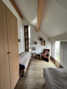 Giường trong phòng chung tại Villa Noordenwind