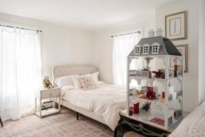 a bedroom with a white bed and a white shelf at Historic Home near Stony Brook Village & Beach in Stony Brook