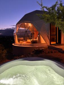 a dome house with a hot tub in front of it at Aguas Claras in Capilla del Monte
