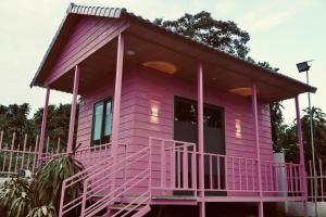 a pink tiny house with a large front porch at Cloudy homestay in Bảo Lâm