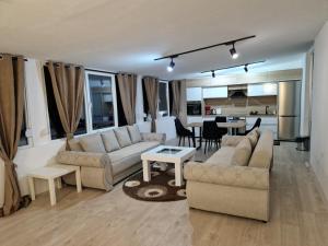 a living room with two couches and a table at Diamond Apartment 2-Luxury in Strumica