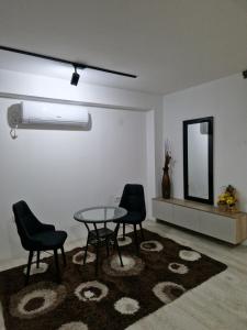 a dining room with a table and chairs and a mirror at Diamond Apartment 2-Luxury in Strumica +2 photos