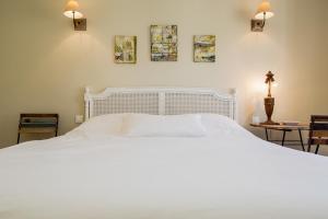 a bedroom with a large white bed with two lamps at Marais Centre Pompidou ID 233 in Paris