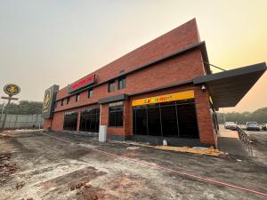 an empty parking lot in front of a building at Round D Clock, IGI Airport in New Delhi