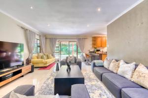 a living room with a couch and a tv at Winston Manor in Gillitts