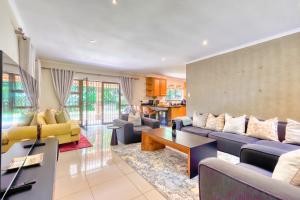 a living room with a couch and a table at Winston Manor in Gillitts