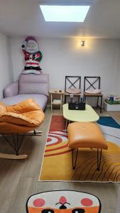 a living room with a couch and a table at BinsHeim HBC - Seoul's Aesthetic Stay with the best Night view Rooftop in Seoul