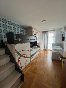 a room with two bunk beds and a staircase at Sarajevo Waves Aparthotel in Sarajevo