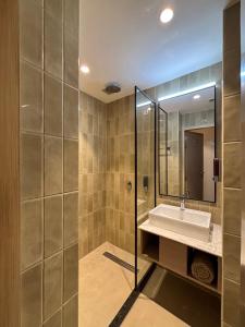 a bathroom with a sink and a mirror at Round D Clock, IGI Airport in New Delhi