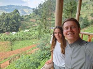 a man and a woman posing for a picture at Rubuguri community home in Rubuguli