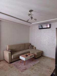 a living room with a couch and a coffee table at Apartment kamal park G39 in Mohammedia