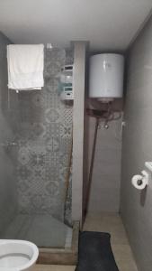 a bathroom with a shower and a toilet at Apartment kamal park G39 in Mohammedia