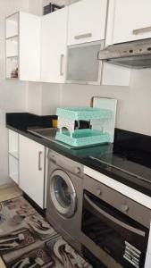 a kitchen with a washing machine on a counter at Apartment kamal park G39 in Mohammedia