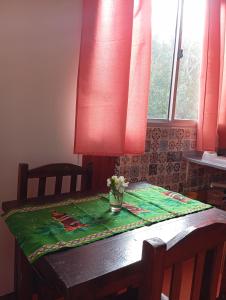 a table with a vase of flowers on top of it at El Romance in Jaureguiberry