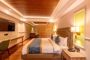 Hotel Tenzing's Glory Darjeeling في دارجيلنغ: غرفة فندق بها سرير ومكتب +18 صورة