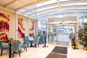 a dining room with chairs and tables in a building at Trip Inn Hotel Astoria in Göttingen