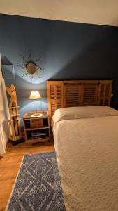 a bedroom with a bed and a table with a lamp at La ruchette in Riez +1 photo