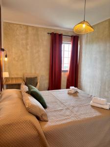 a bedroom with a large bed with pillows on it at Casa de Campos AL in Angra do Heroísmo